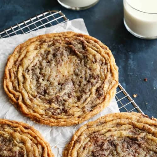 3 giant pan-banging chocolate chip cookies on a cooling rack