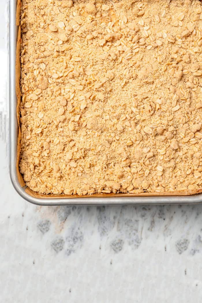 A brown sugar oat crumble mixture doubles as a crust and a topping for these easy Apple Pie Bars. The perfect fall treat for a crowd!
