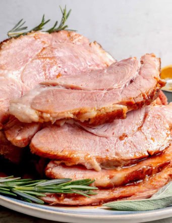 cooked ham on a platter, sliced