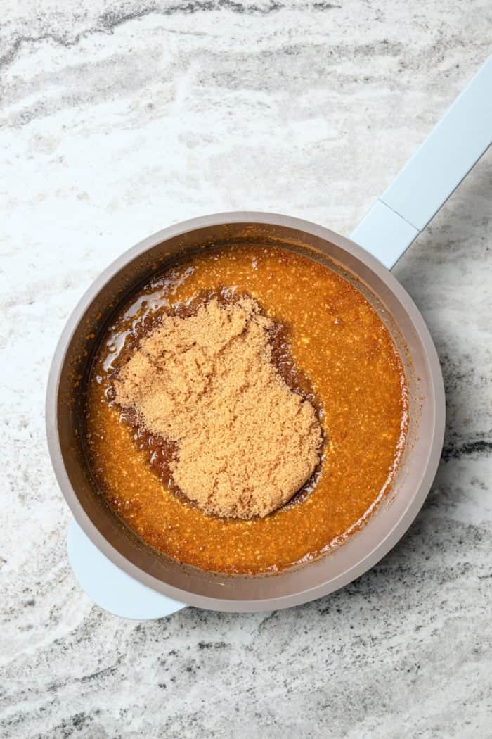 This Orange-Brown Sugar Ham Glaze is sweet and citrusy, but mustard, balsamic vinegar and warm spices add depth too. Easy and delicious! Ingredients for orange-brown sugar ham glaze in saucepan.