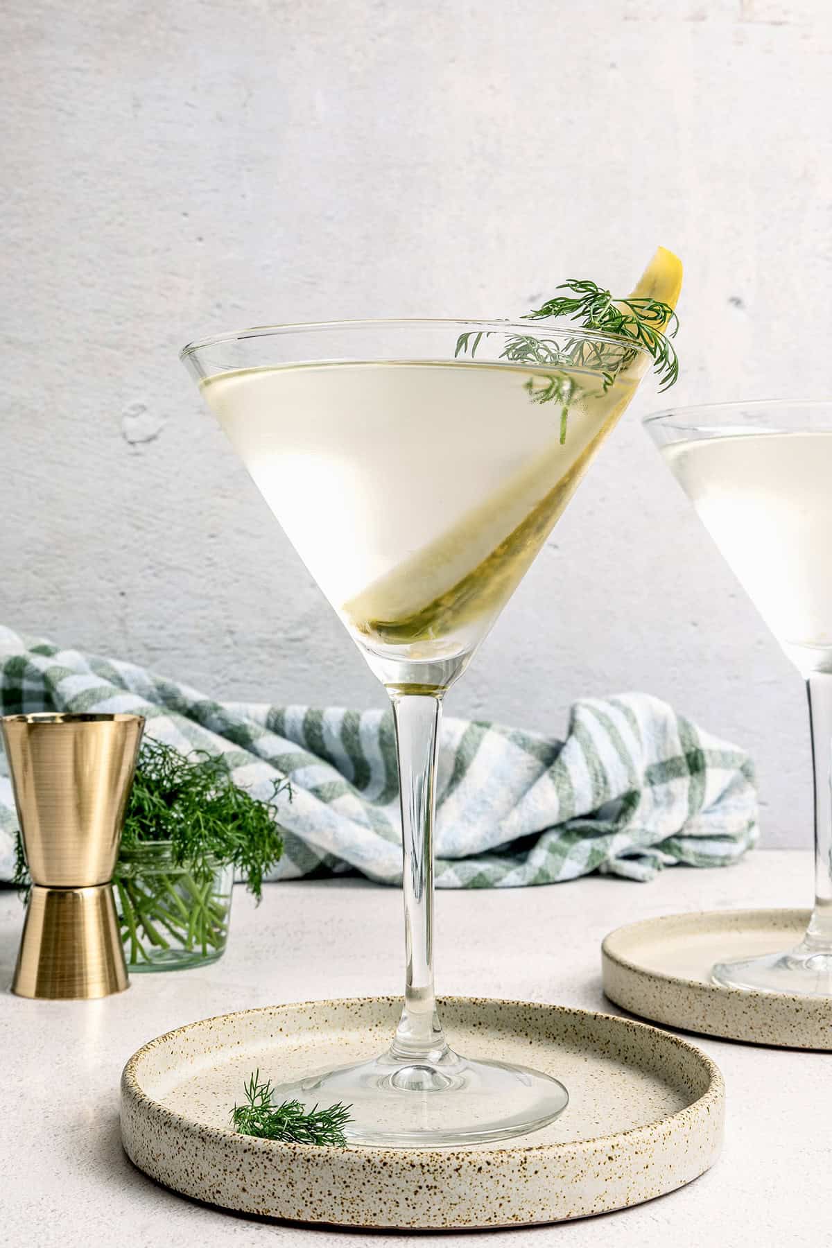 Inspired by the classic dirty martini recipe, pickle brine adds a pop of bold, briny flavor to this savory and smooth pickle martini. a pickle juice martini in a martini glass