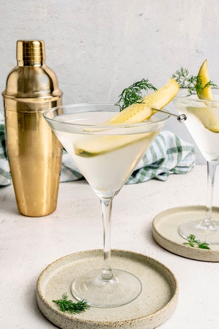 Inspired by the classic dirty martini recipe, pickle brine adds a pop of bold, briny flavor to this savory and smooth pickle martini. a pickle juice martini in a martini glass