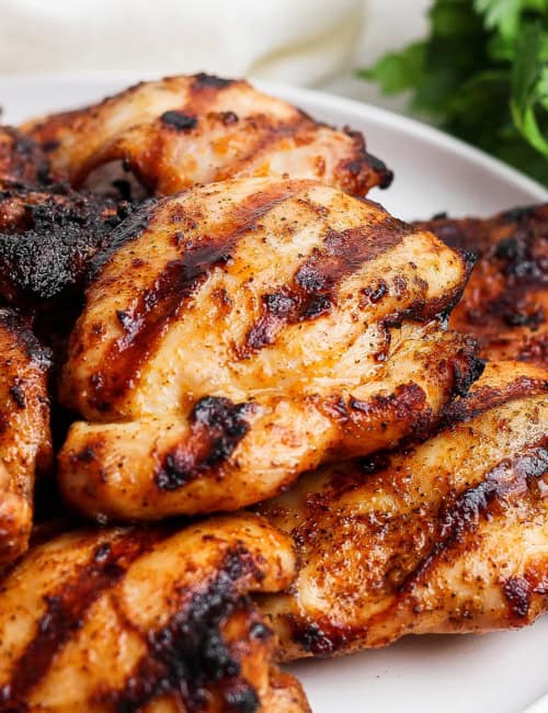 Grilled chicken thighs on platter.