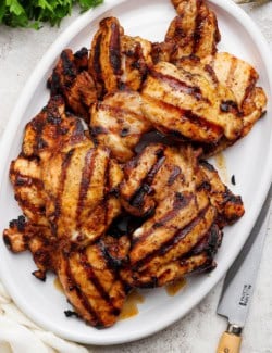 Platter of grilled chicken thighs.