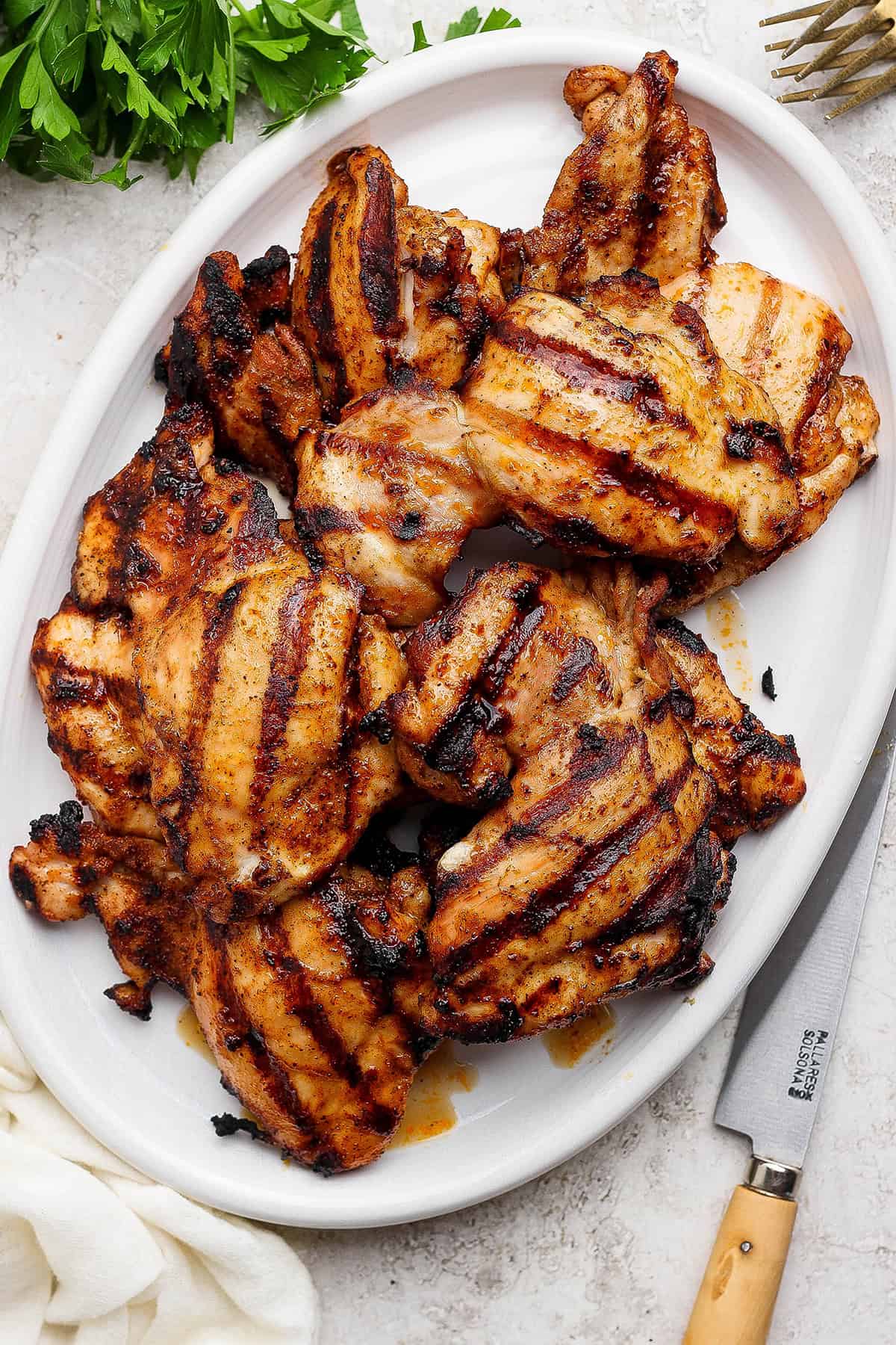 Platter of grilled chicken thighs.