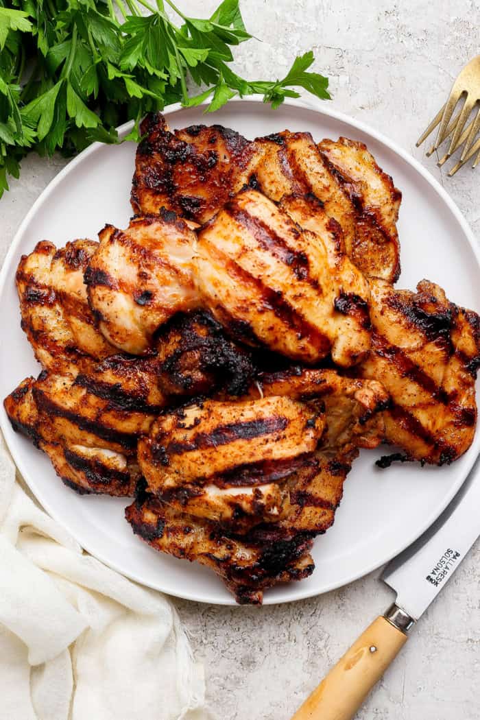 Grilled chicken thighs on plate.