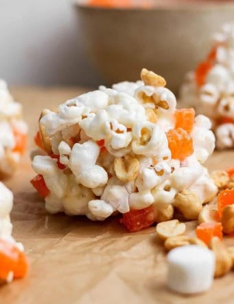 marshmallow popcorn balls with peanuts and chopped orange gumdrops