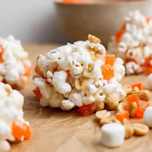 marshmallow popcorn balls with peanuts and chopped orange gumdrops
