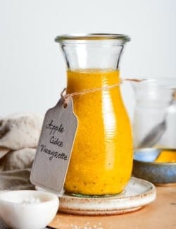 Homemade apple cider vinaigrette in glass bottle.