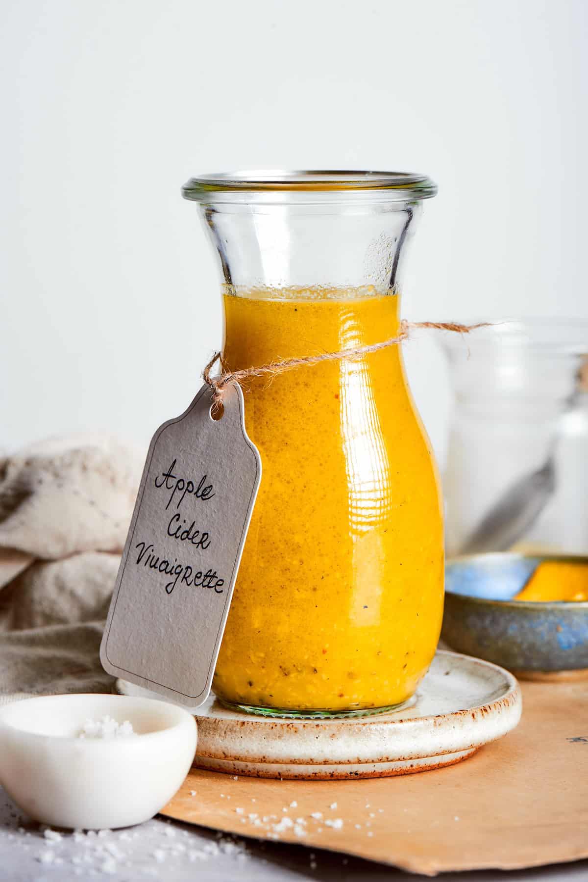 Homemade apple cider vinaigrette in glass bottle.