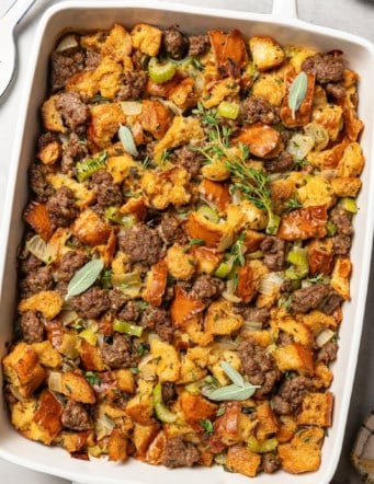 overhead photo of stuffing with sausage in a rectangular white baking dish