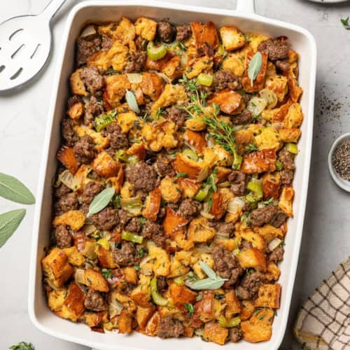 overhead photo of stuffing with sausage in a rectangular white baking dish