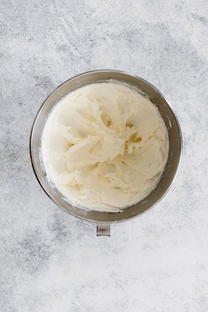 a mixing bowl with creamed butter and sugar