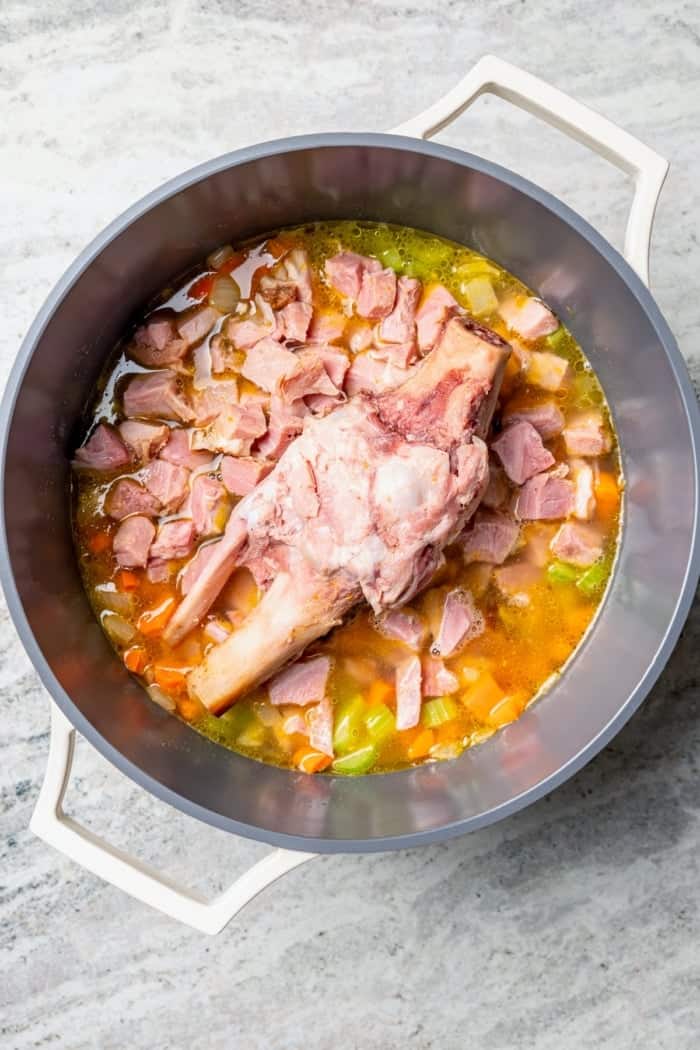 Ham and bone added to pot of soup.