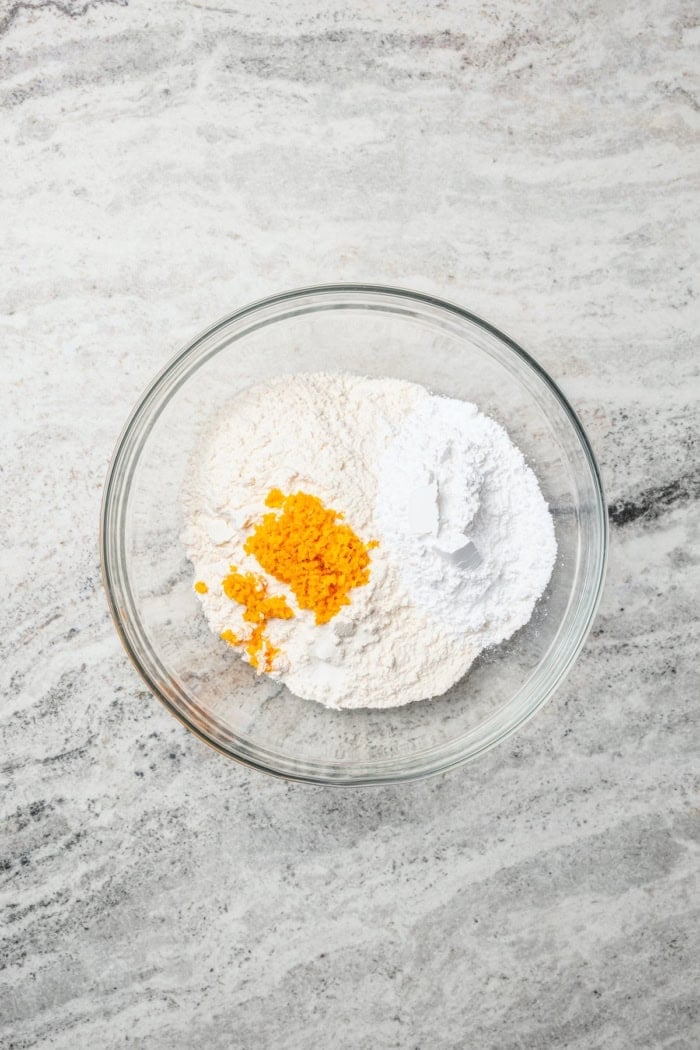 These Pecan Pie Bars have a caramel filling, buttery shortbread crust and NO corn syrup! Honey and brown sugar adds the perfect sweetness. Dry ingredients for shortbread crust in glass bowl.