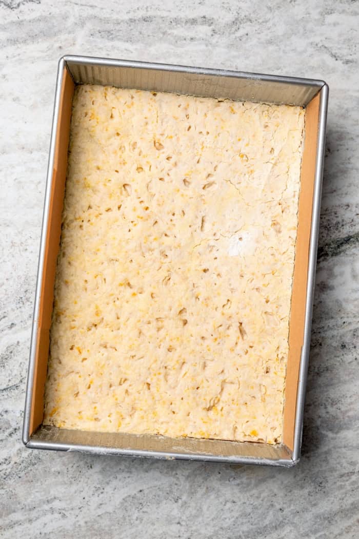 These Pecan Pie Bars have a caramel filling, buttery shortbread crust and NO corn syrup! Honey and brown sugar adds the perfect sweetness. Shortbread crust in pan.