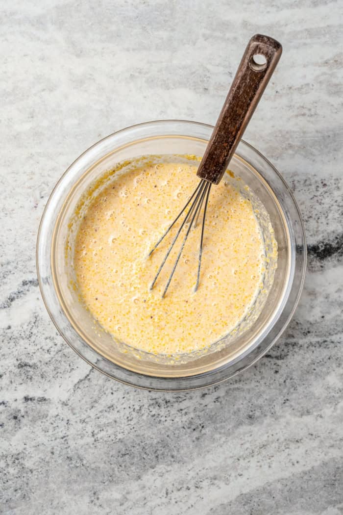 Whisking cornmeal mixture in bowl.