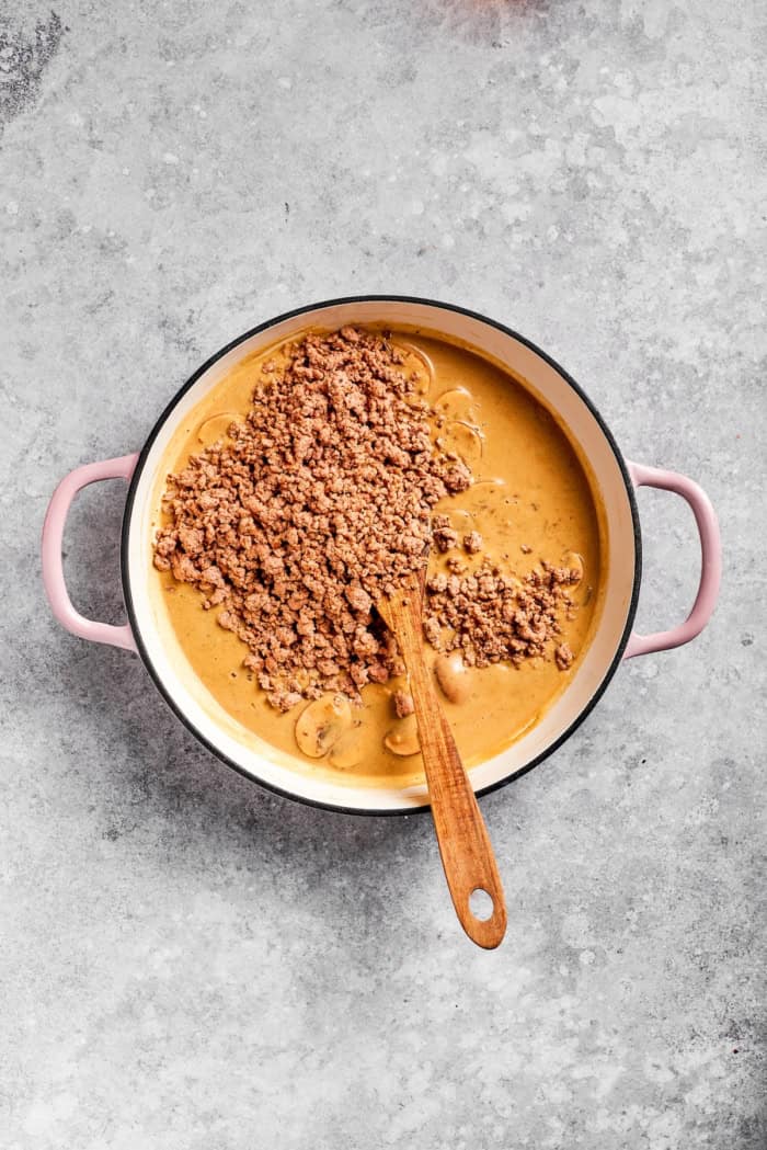Ground beef added to pan of stroganoff sauce.