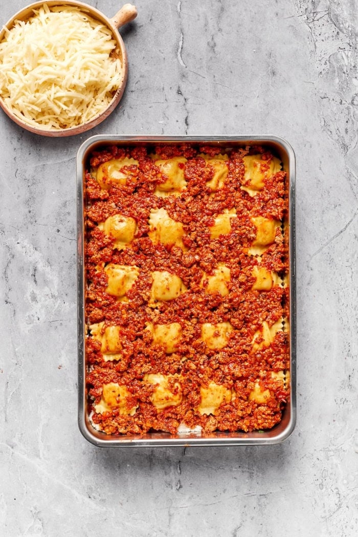 Meat sauce layer added to ravioli lasagna.