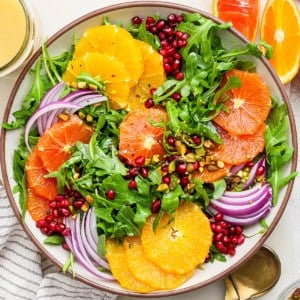 overhead photo of a winter salad with fresh citrus slices and pomegranate arils