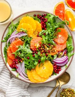 overhead photo of a winter salad with fresh citrus slices and pomegranate arils