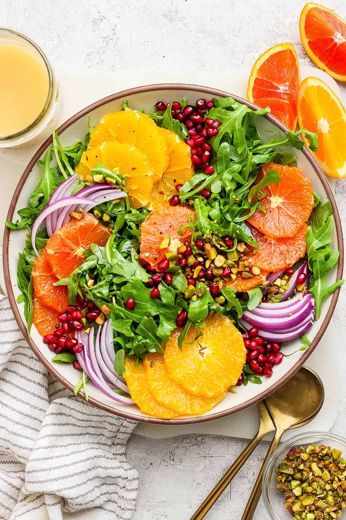 overhead photo of a winter salad with fresh citrus slices and pomegranate arils