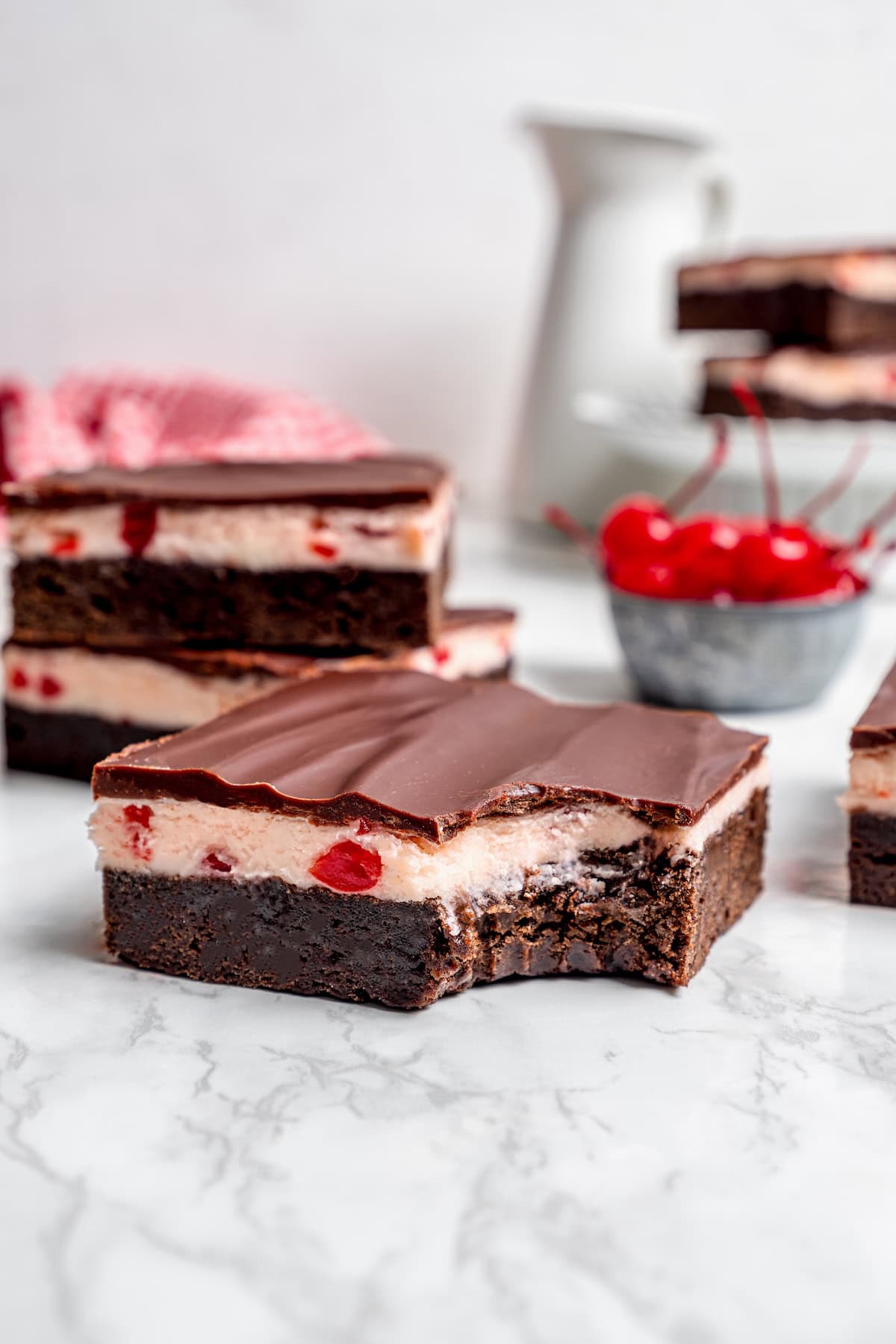 a bite taken out of a cherry brownie