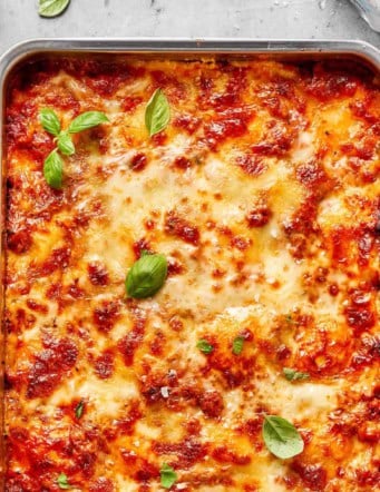 overhead photo of lazy ravioli lasagna baked in a metal 9x13 pan