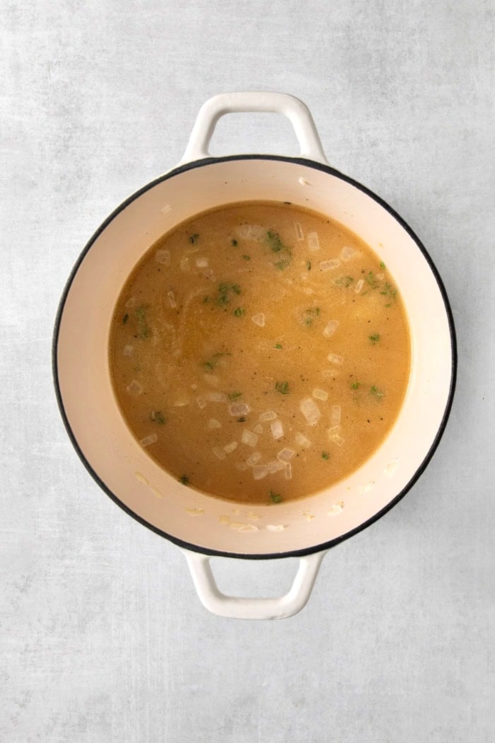 This creamy cheesy rice is made with cheddar and Parmesan for double the cheesy goodness. An easy side dish that pairs with any meal! Chicken broth added to pot of rice and aromatics.