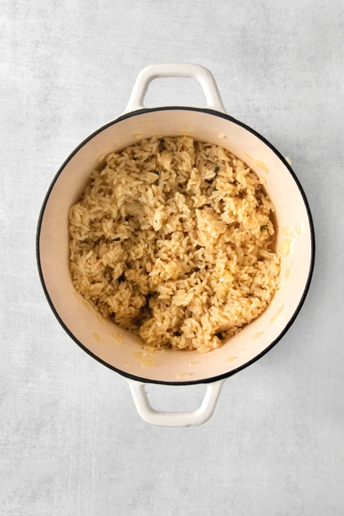 This creamy cheesy rice is made with cheddar and Parmesan for double the cheesy goodness. An easy side dish that pairs with any meal! Pot of rice cooked in chicken broth.