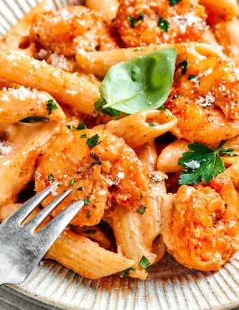 an individual serving of Cajun shrimp pasta on an earth-toned plate