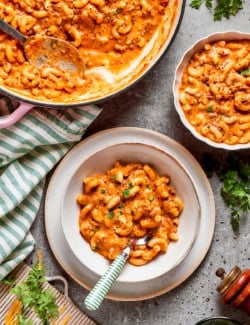 a pot of hamburger helper and two single servings in bowls