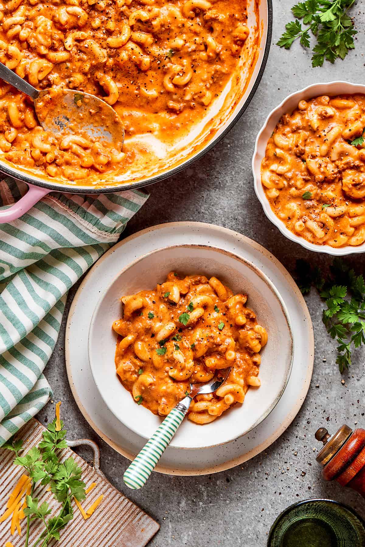 a pot of hamburger helper and two single servings in bowls