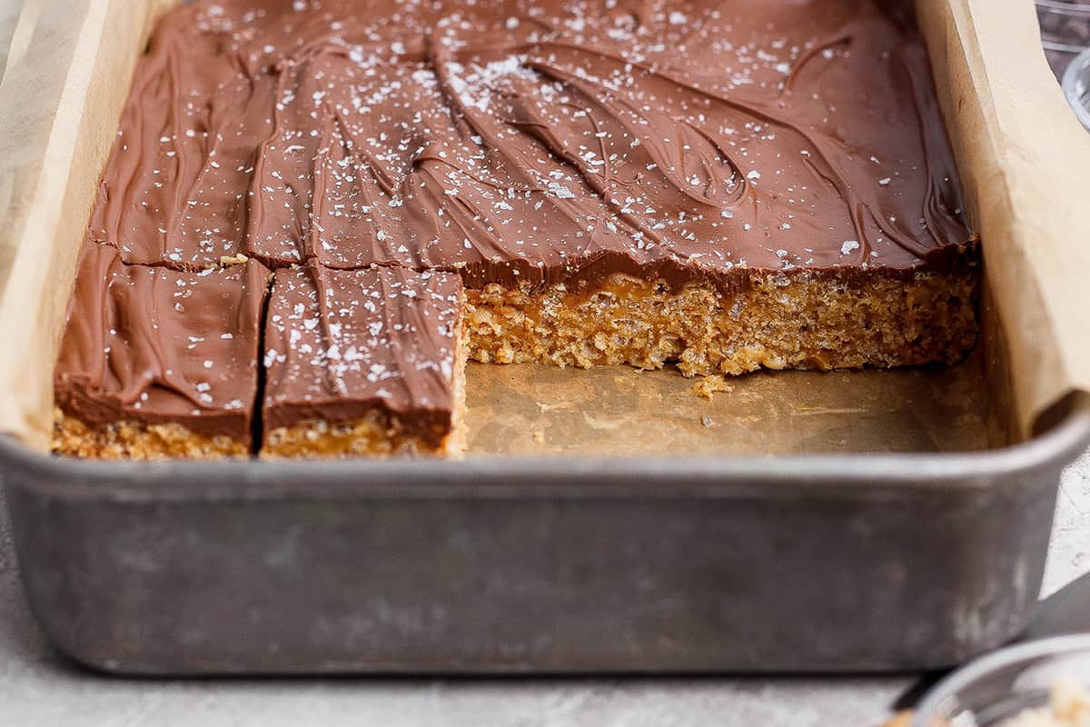 These scotcheroos are chewy, chocolatey, and peanut buttery, with a little sea salt to take them up a notch. An easy no-bake dessert recipe! Baking dish with scotcheroos.