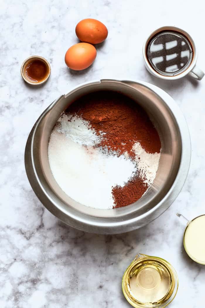 dry chocolate cake ingredients in a stainless steel mixing bowl
