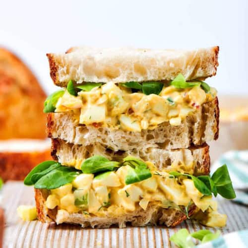 close-up photo of a stack of egg salad sandwiches