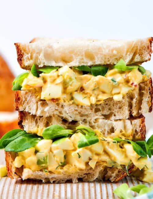 close-up photo of a stack of egg salad sandwiches