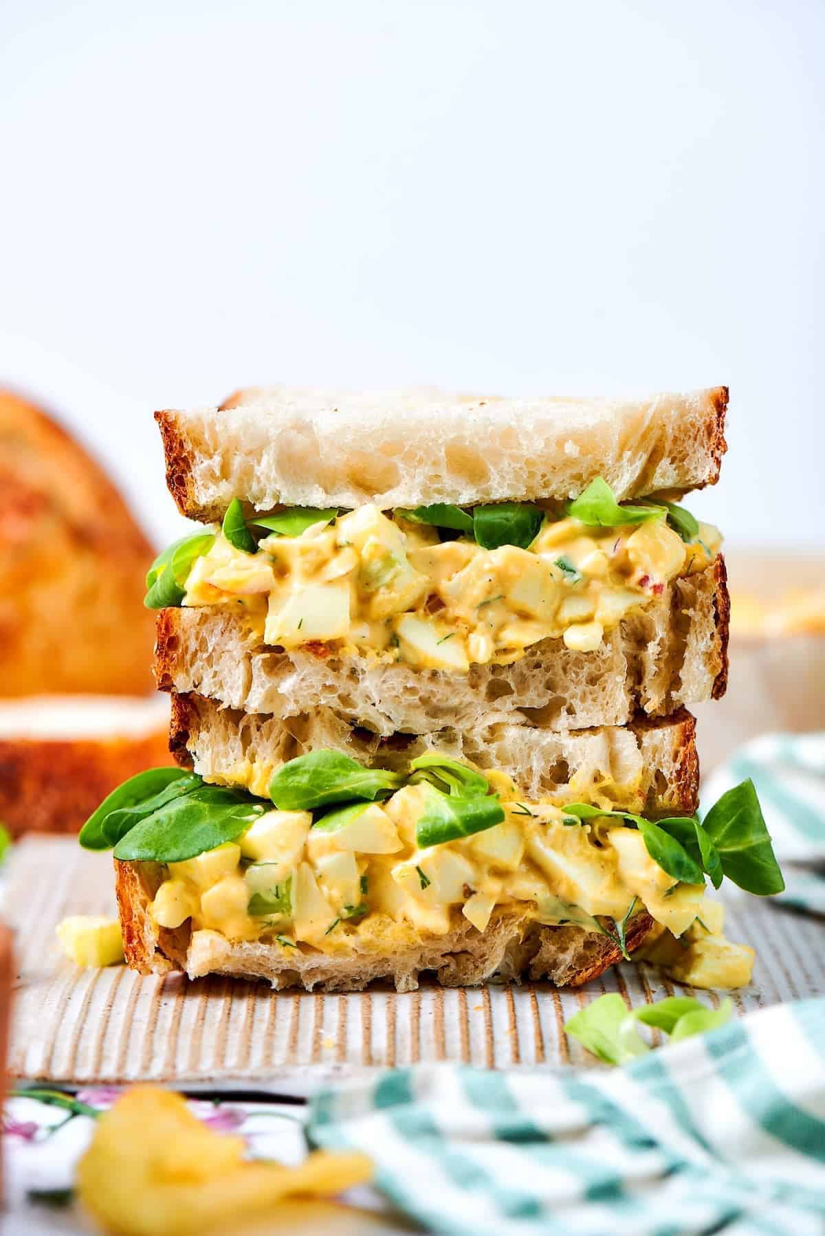 close-up photo of a stack of egg salad sandwiches
