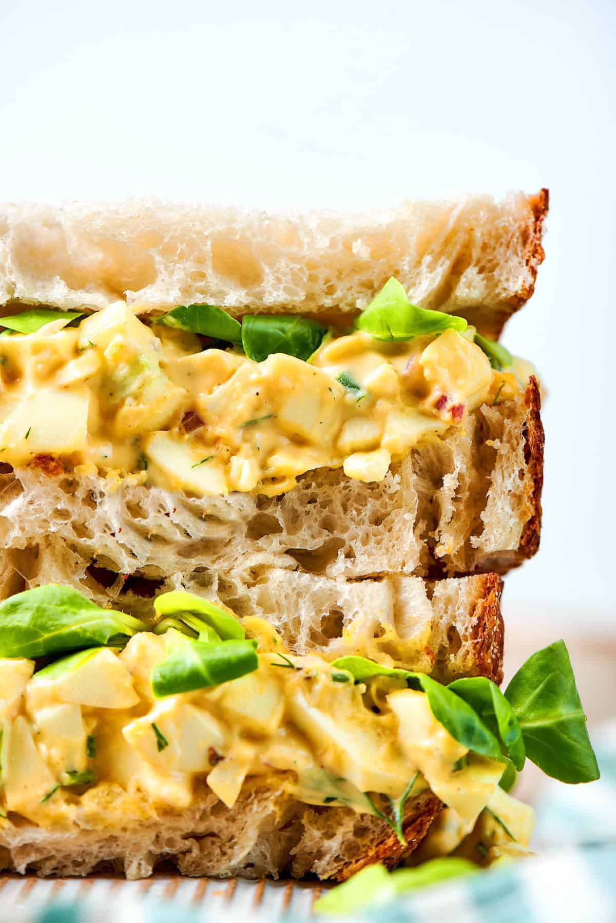 close-up photo of a stack of egg salad sandwiches