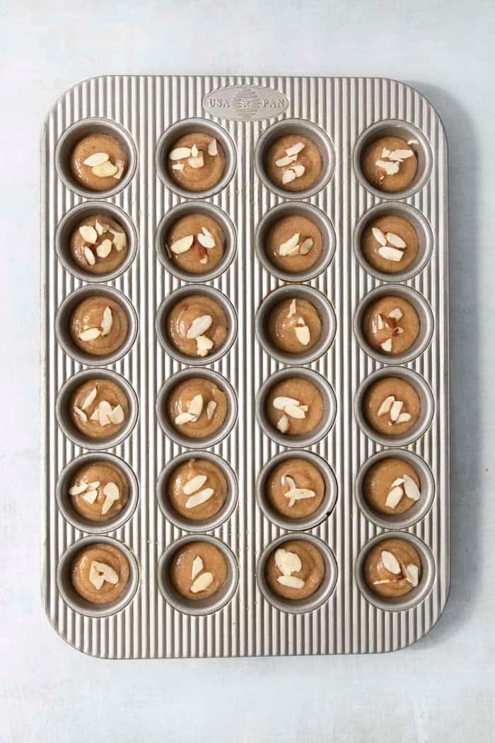 Unbaked financiers in muffin tin.