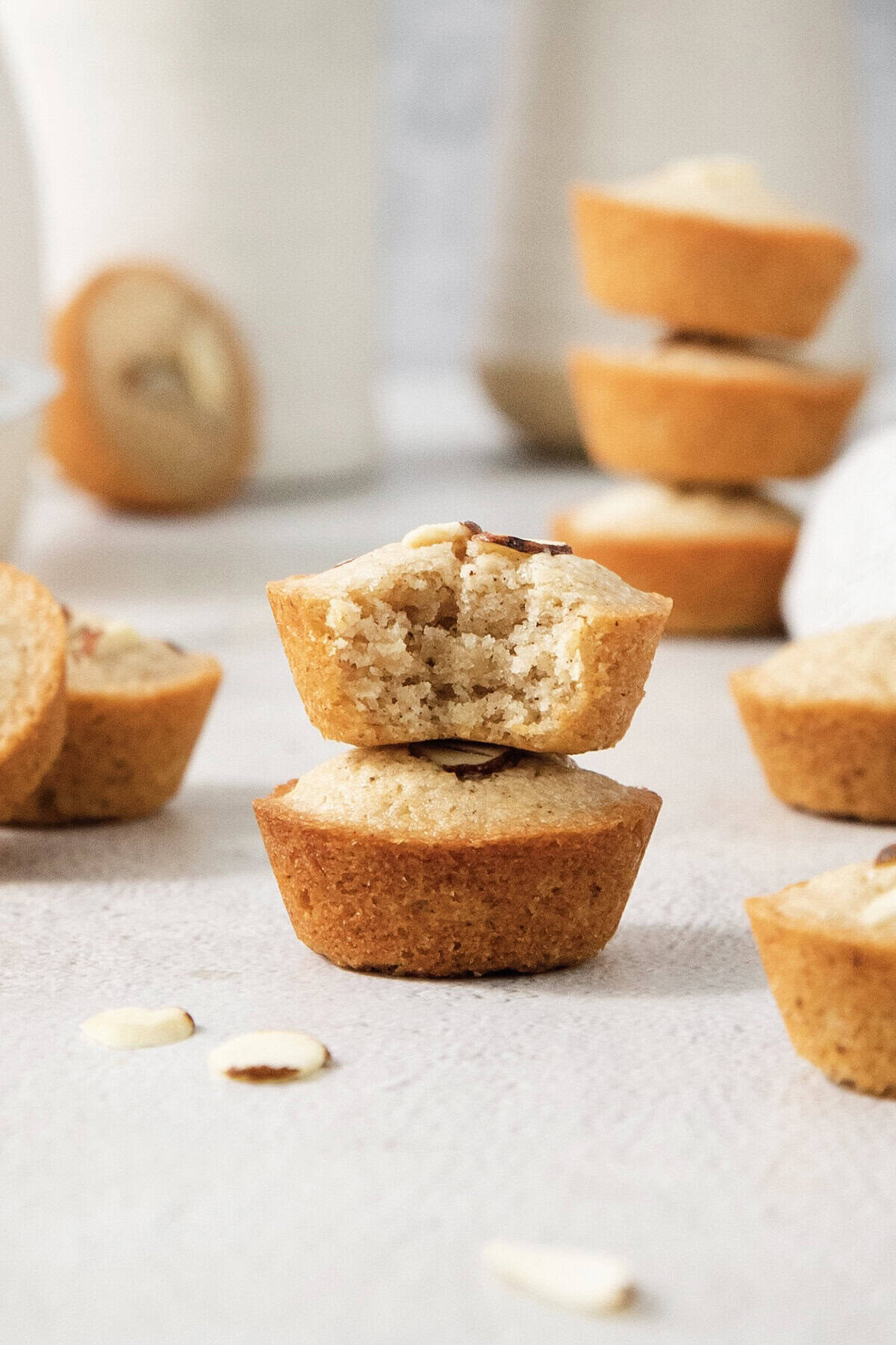 Stack of two financiers, with top one bitten to show tender crumb.