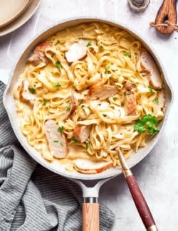 Chicken fettuccine alfredo in skillet.
