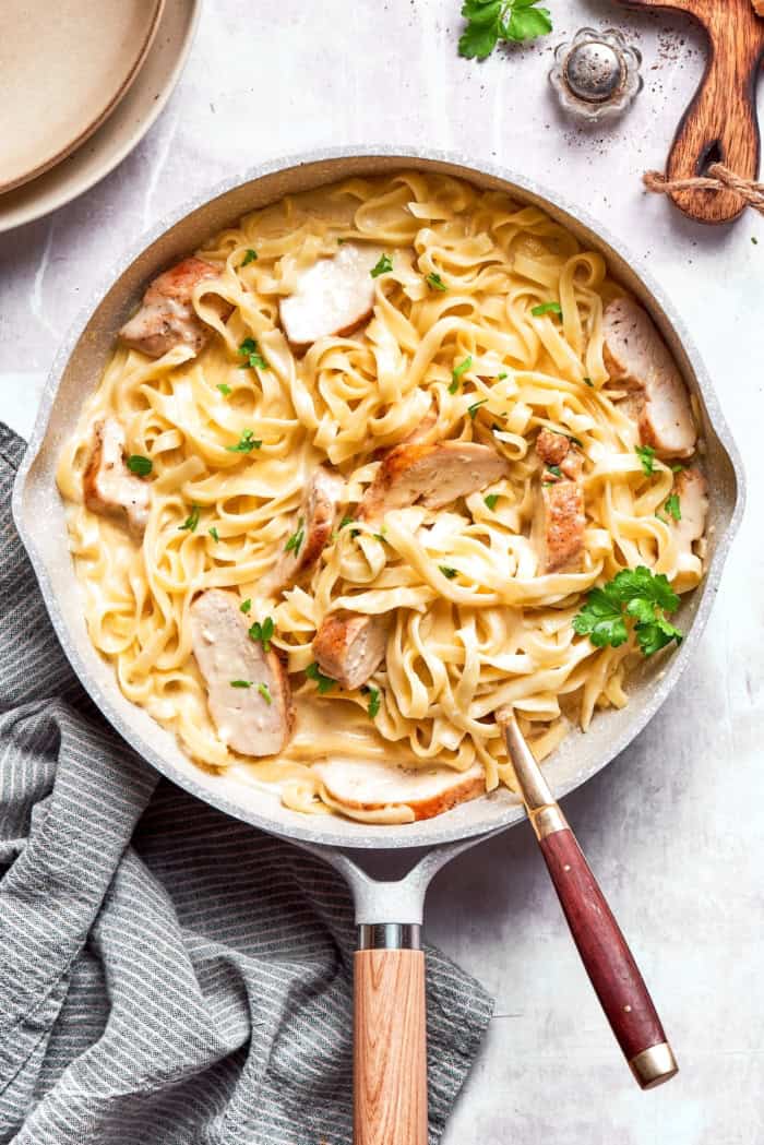 Chicken fettuccine alfredo in skillet.