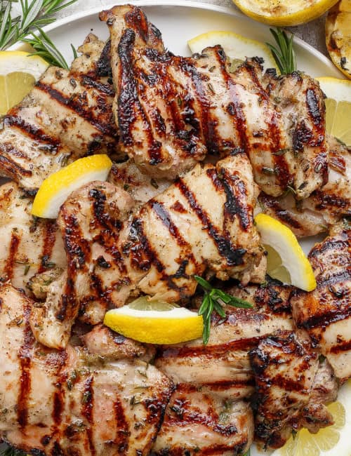 Grilled lemon chicken thighs on platter.