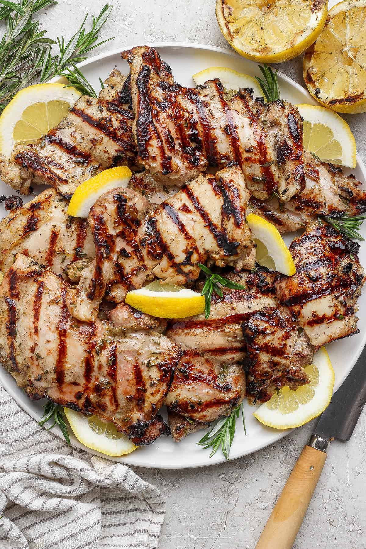 Grilled lemon chicken thighs on platter.