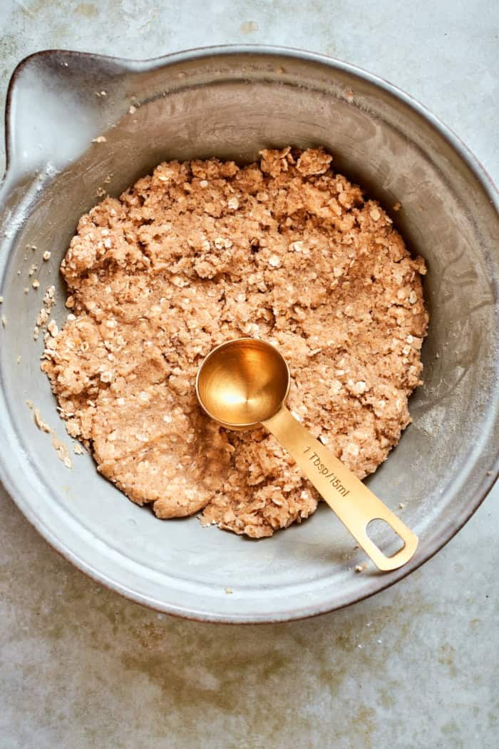 oat cookie dough in a bowl, with a tablespoon measure