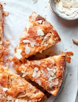 Two slices of Norwegian rhubarb cake pulled away from rest of cake.