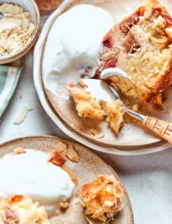 Slices of Norwegian rhubarb cake on plates with ice cream.