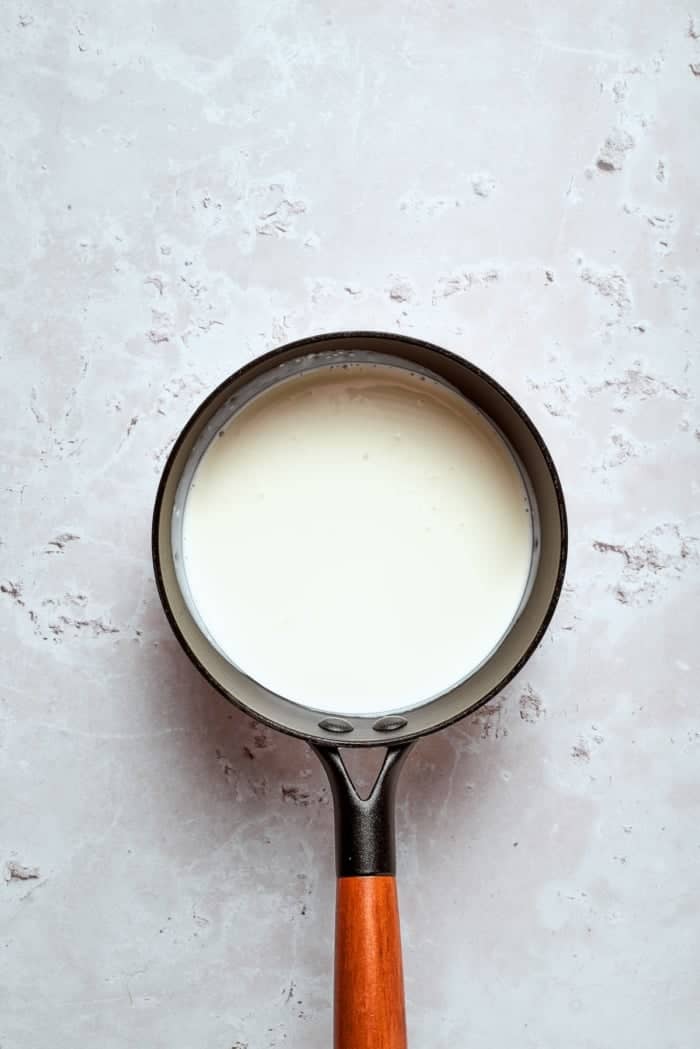 This homemade rhubarb ice cream is ultra creamy, with tart rhubarb flavor and a lovely blush-pink color. Such a fun summer dessert! Milk mixture in saucepan.