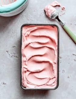 Loaf pan with rhubarb ice cream inside.